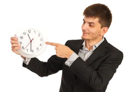 Executive man indicate to clock Foto stock