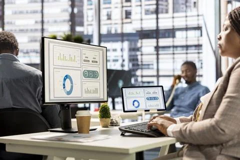 Executive manager in modern office engaged in infographics analysis Stock Photos