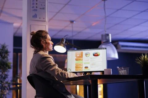 Executive manager sitting at desk table in startup office working overhours Stock-Fotos