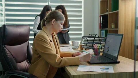 Executive manager taking notes on financial documents to create data charts Stock Footage 295810466