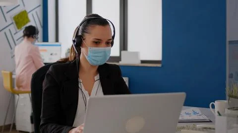 Executive manager wearing protective face mask and headphone Stock Photos