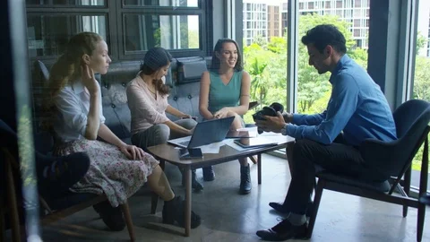 Executive offering vr headset to his colleagues in office Stock Footage 75452464