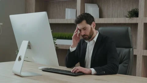 An executive or an office worker closing his eyes from the tiredness, and Stock Footage 171350856