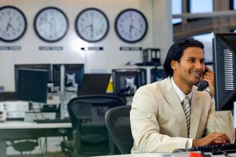 Executive on the phone in open space office Stock Photos