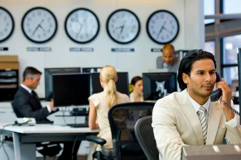 Executive on the phone in open space office Stock Photos