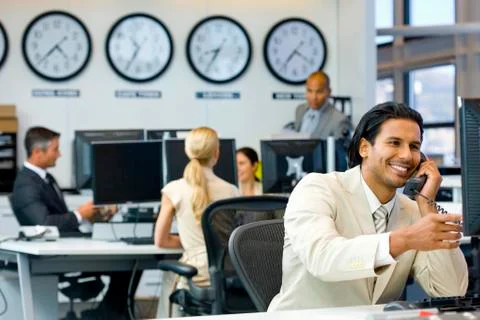 Executive on the phone in open space office Stock Photos