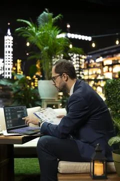 Executive professional reviews documents based on AI chatbot on laptop Stock Photos