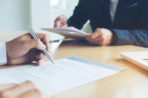 Executive reading a resume during a job interview and businessman Completin.. Foto stock