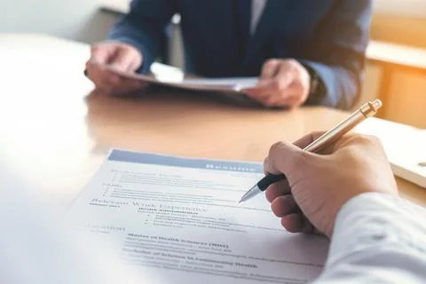 Executive reading a resume during a job interview and businessman Completin.. Foto stock