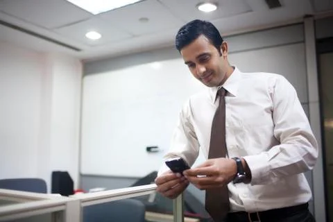 Executive reading sms on mobile phone Stock Photos