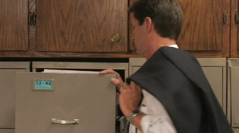 Executive Retrieving the File Video stock 505450
