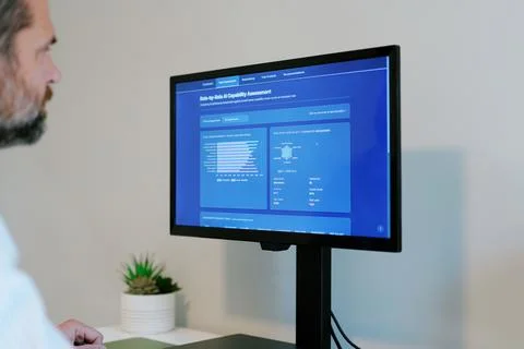 Executive Reviewing AI Workforce Automation Data Фото