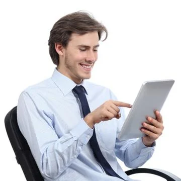 Executive sitting on a chair browsing a tablet Stock Photos