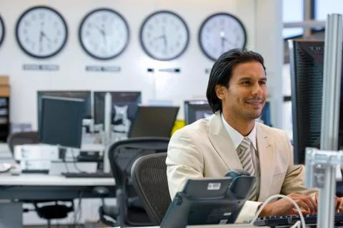 Executive sitting in open space office Stock Photos