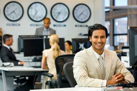 Executive sitting in open space office Stock Photos