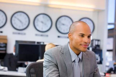 Executive sitting in open space office Stock Photos