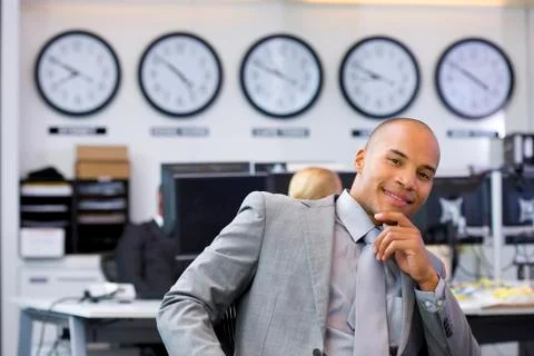 Executive sitting in open space office Stock Photos