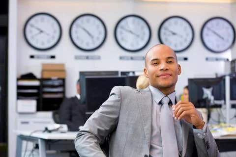 Executive sitting in open space office Stock Photos
