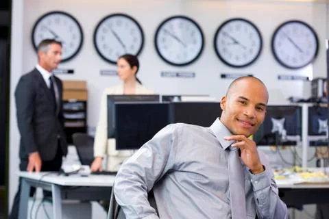 Executive sitting in open space office Stock Photos