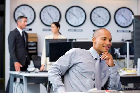 Executive sitting in open space office Stock Photos