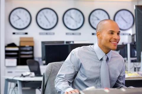 Executive sitting in open space office Stock Photos