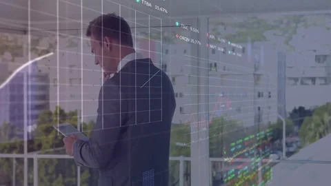 Executive tapping tablet by glass window analyzing market data and activating Stock Footage 311901430