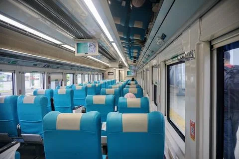 Executive train interior with rows of comfortable seats and an elegant Stock Photos