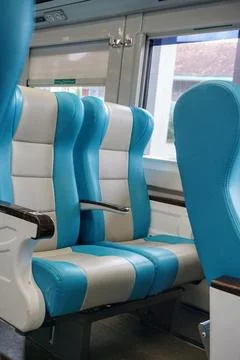 Executive train interior with rows of comfortable seats and an elegant Stock Photos