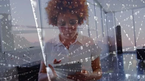 An executive using a digital tablet in an office setting, with binary code Stock Footage 328586668