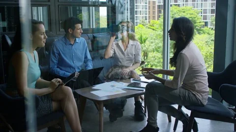 Executive using virtual reality headset while discussing with colleagues Stock Footage 75451861