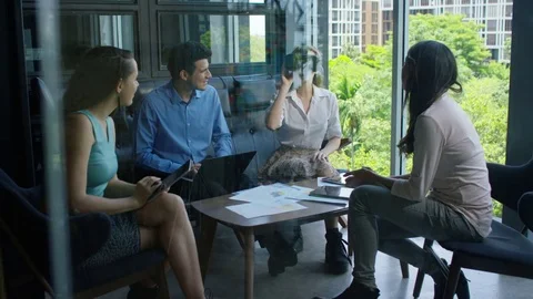 Executive using virtual reality headset while discussing with colleagues Stock-Footage 75451880