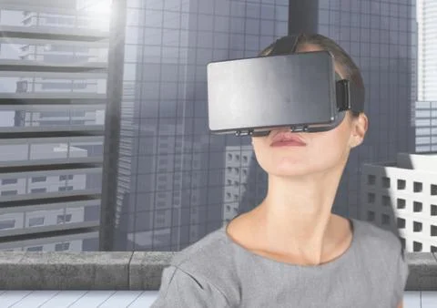 Executive using virtual reality headset against office building Fotos de archivo