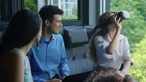 Executive using vr headset while colleagues discussing with each other in office Stock Footage 75451907