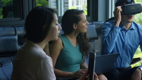 Executive using vr headset while colleagues discussing with each other in office Stock Footage 75451918