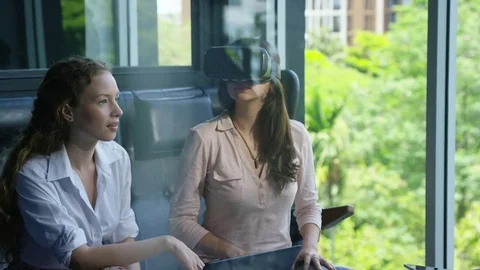 Executive using vr headset while having meeting with her colleagues in office Stock Footage 75452138