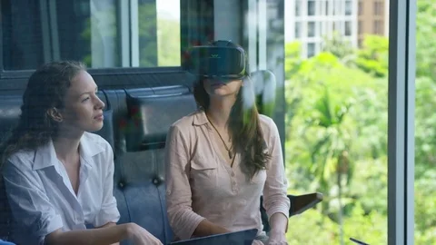 Executive using vr headset while having meeting with her colleagues in office Stock Footage 75452188