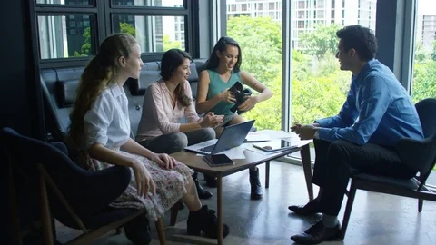 Executive using vr headset while colleagues discussing with each other in office Stock-Footage 75452601
