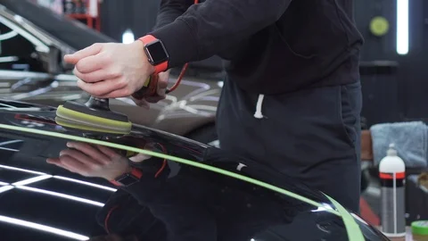 Executive worker of bus station polishes the hood of the car to a mirror shine Stock Footage 115934442