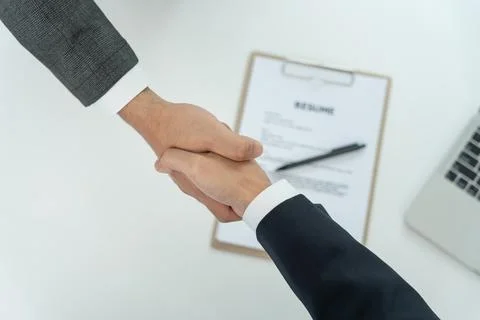Executives accept job application and shake hand, documents and job applica.. Foto stock
