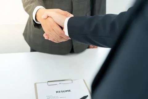 Executives accept job application and shake hand, documents and job applica.. Фото