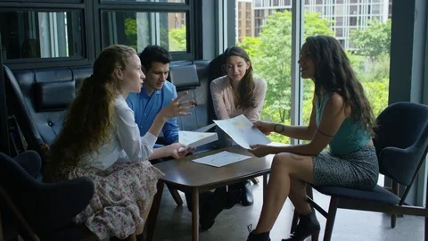 Executives discussing with each other in office Stock Footage 75451668