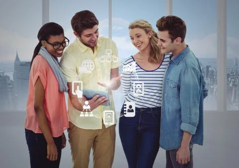 Executives discussing over digital tablet and networking icons in office 스톡 사진