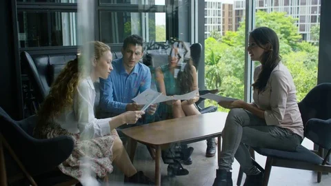 Executives discussing over document in office Stock Footage 75451579