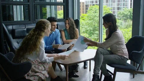 Executives discussing over document in office Stock Footage 75451599