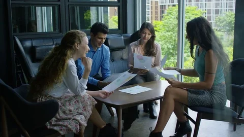 Executives discussing over document in office Stock Footage 75451650