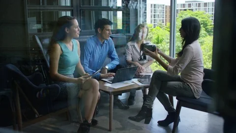 Executives discussing over virtual reality headset in office Stock Footage 75452377