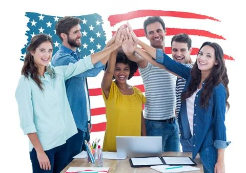 Executives doing hand stack against american flag in background at office Foto stock