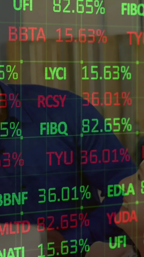 Executives enjoy office fun amidst dynamic stock market data display. Stock Footage 321991486