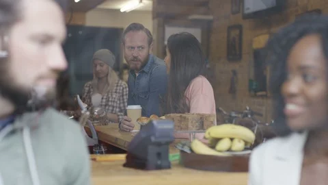 Executives having coffee and two women collecting take-away coffee from counter Stock Footage 108011719