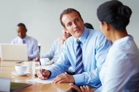 Executives having a quick discussion. Two executives conversing in board room Stock Photos